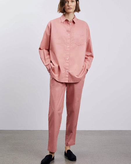 Pantalon en rose avec une coupe élégante, finition soignée et tissu léger.